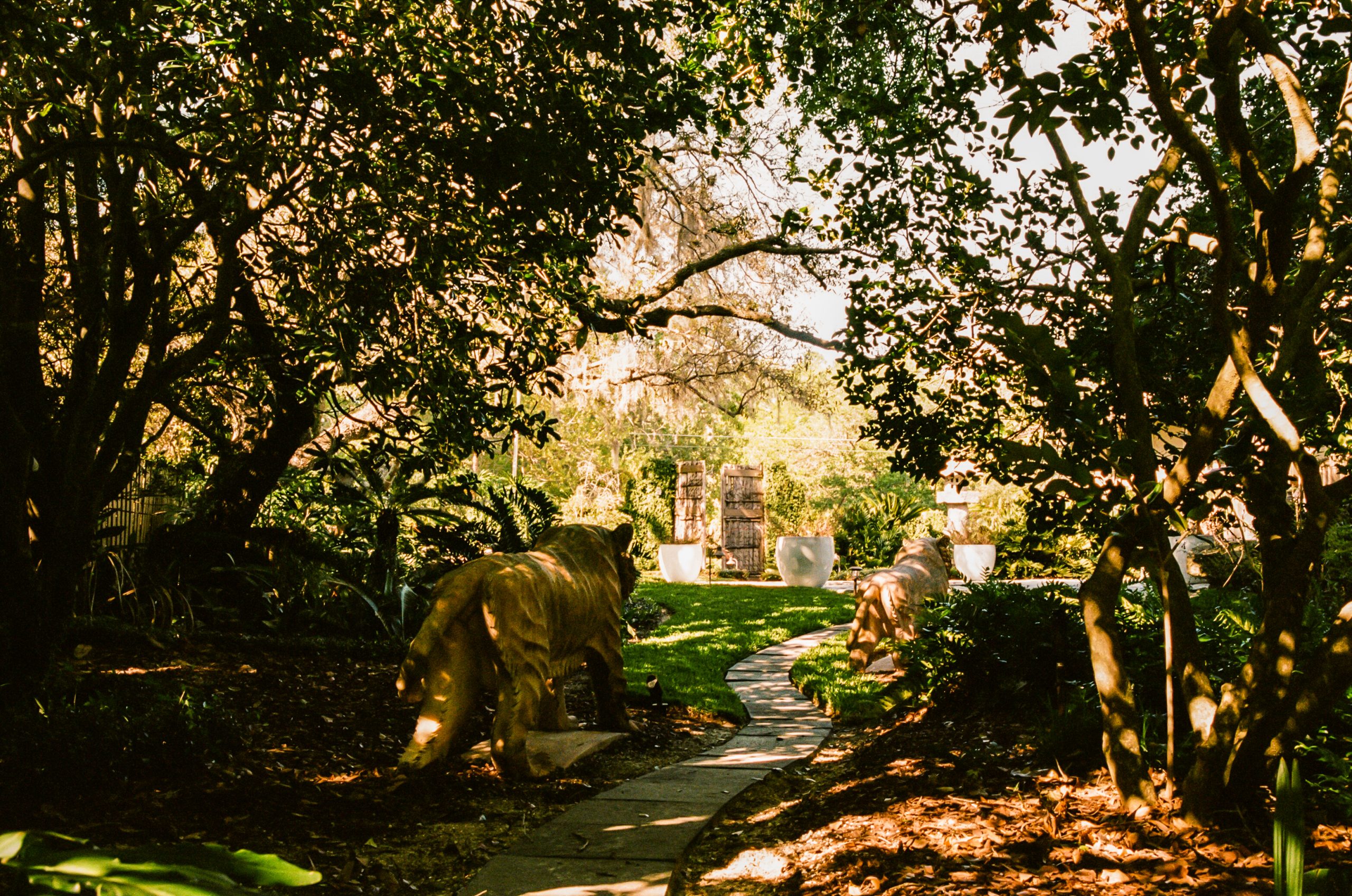 Lush green exterior of Center Street with sculptures.